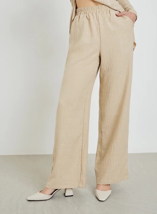 Ensemble composé d'un haut beige brodé texturé et d'un pantalon large