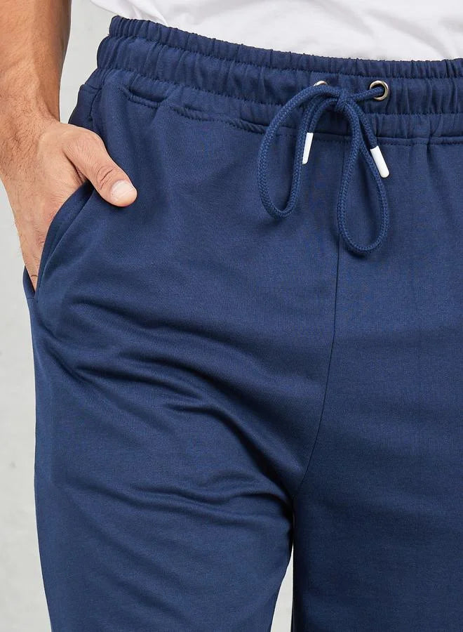 Pantalon de jogging oversize à jambes droites et ourlet ouvert avec boutons-pression